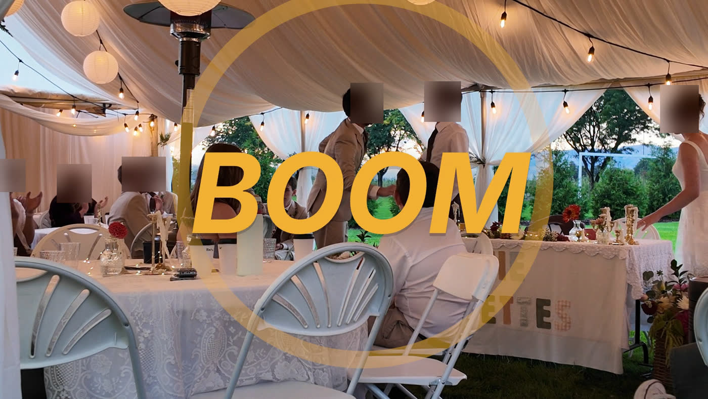 BOOM in big amber letters with a shockwave ring over the reception tent