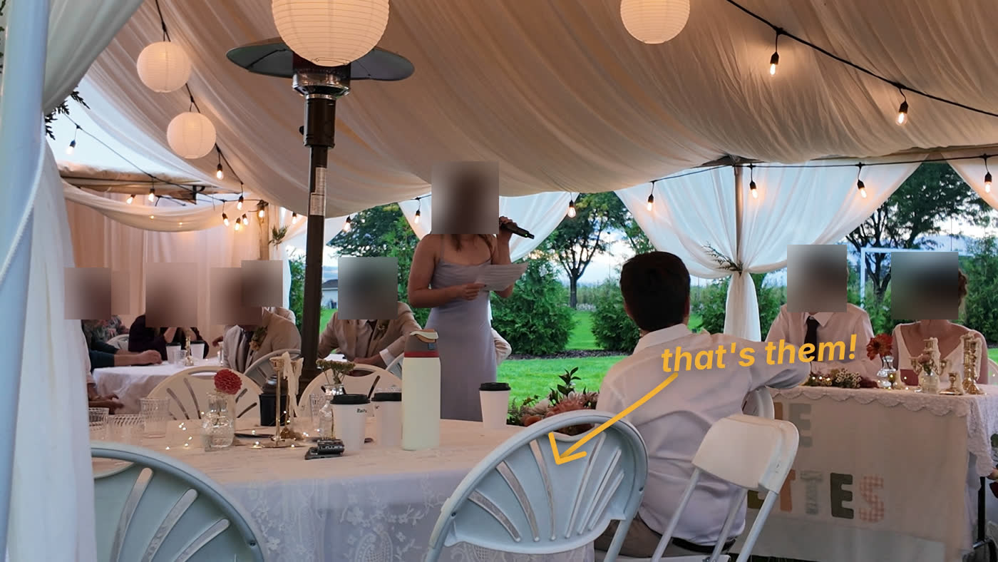 A toast in a reception tent, with a hand-drawn amber arrow and “that's them!” pointing at the caption