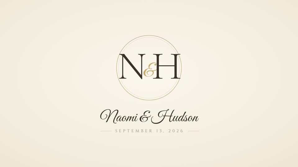 Monogram card: initials in a fine gold ring on ivory paper, names in script and the date