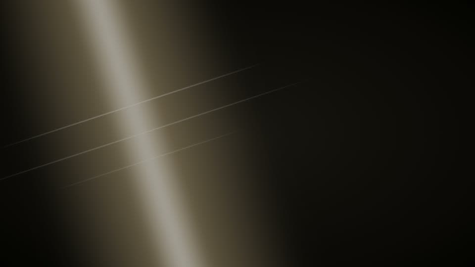 A diagonal band of warm light across a dark frame